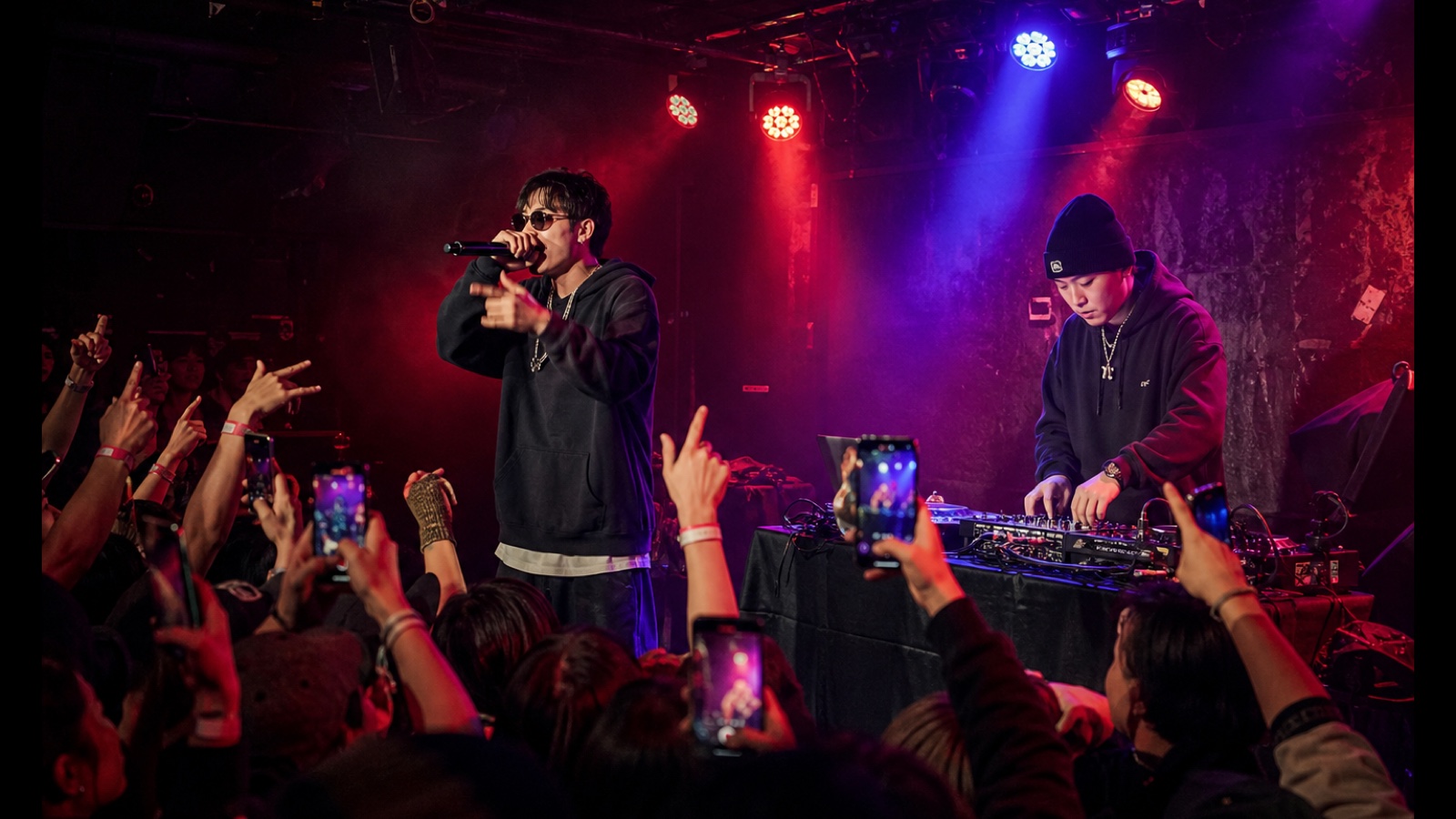 AI-generated editorial scene of a fictional Korean hip-hop performer and DJ in an intimate Paris club.