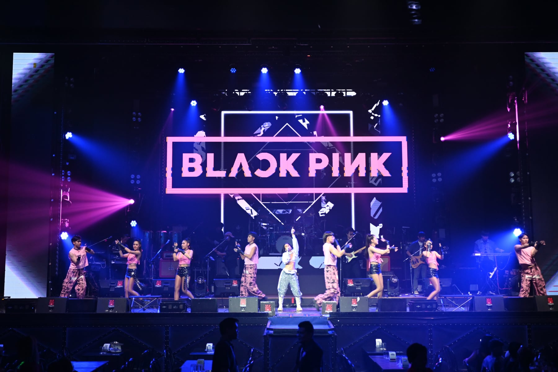 A BLACKPINK concert stage with dancers and blue and pink lighting on 9 November 2025.