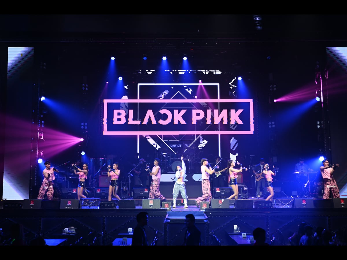 A BLACKPINK concert stage with dancers and blue and pink lighting on 9 November 2025.