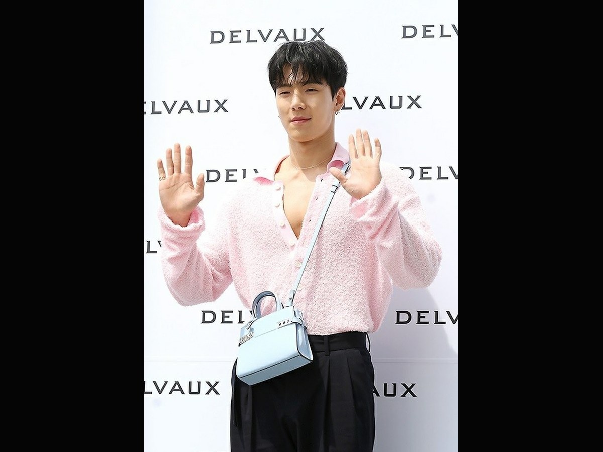 Paris Fashion Week 2026: Shownu and Hyungwon Are Confirmed for Concept Korea. Archive image: Shownu at a 2023 Delvaux event; not evidence of current Paris Fashion Week attendance.